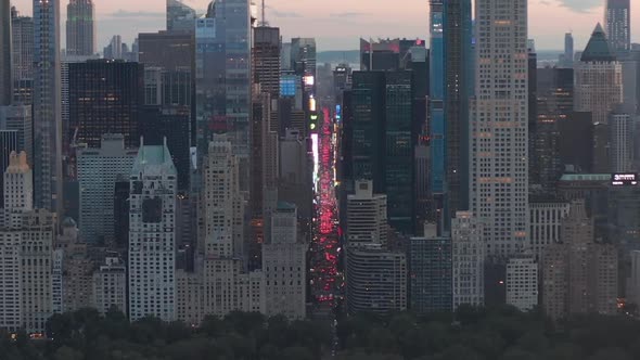 AERIAL: View of 7Th Avenue Traffic and Times Square Over New York City Central Park at Sunset with