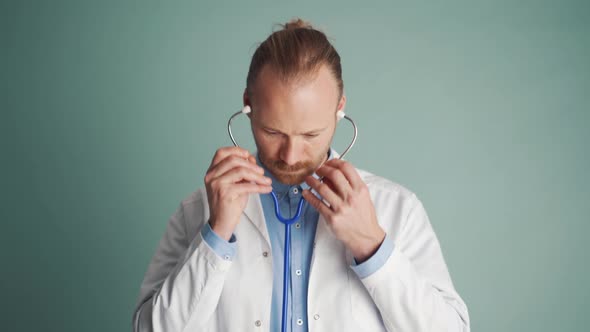 Serious doctor wearing a stethoscope