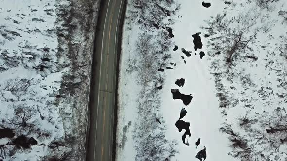 Flying over country road with snow to the sides.