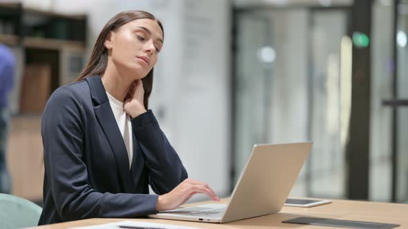 Tired Businesswoman with Neck Pain in Office 
