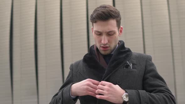 Close up of a businessman wearing a coat