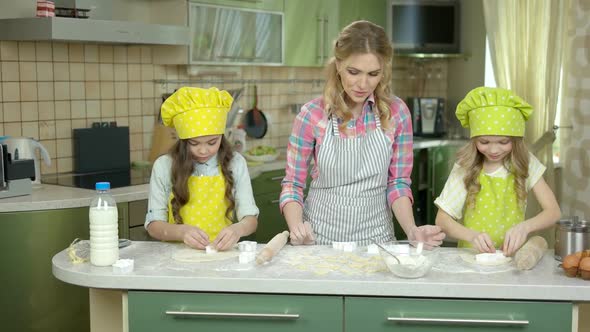 Mother with Daughters Cooking Pastry.