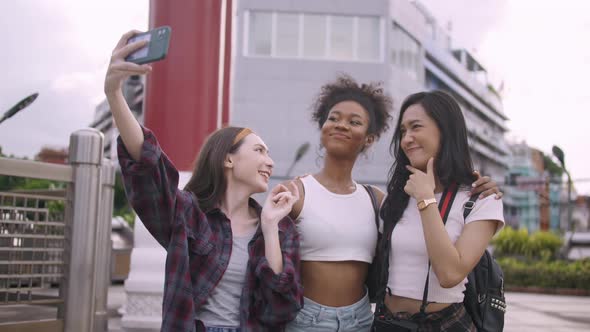 Young tourists having fun taking pictures together.