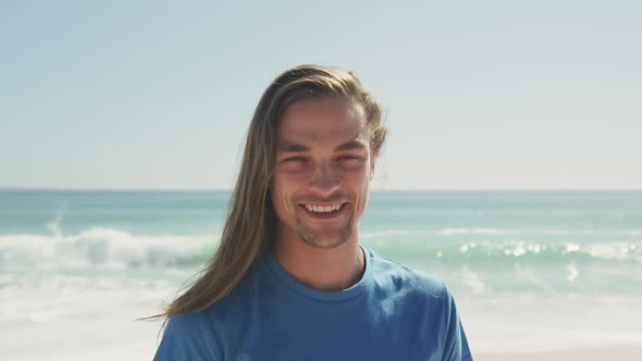 Caucasian man looking at the camera at beach