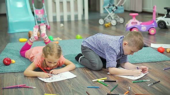 Kids Drawing with Pencils and Felt Pens at Home