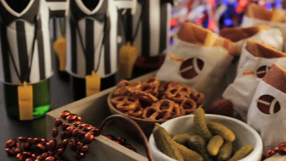 Game day football party table with  sub sandwich and snacks.