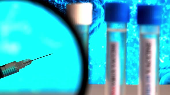 Doctor Holds Syringe with Ampoules Covid19 Vaccine on a Laboratory Bench