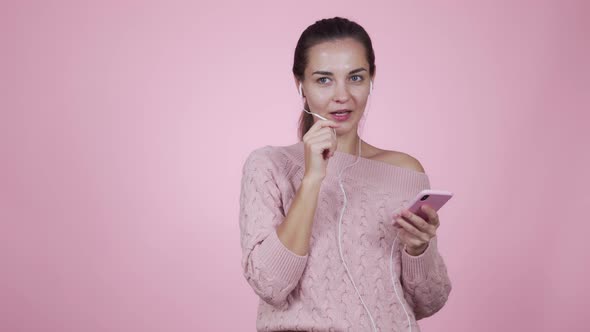 Woman Talking on Video Chat Using Mobile Phone Isolated on Pink Background