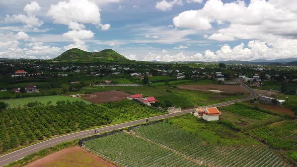 Aerial View of Countryside Village with Highway Green Farms and Hills