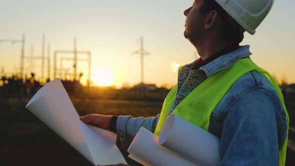 Architect Worker Checking Construction Project On Electric Tower