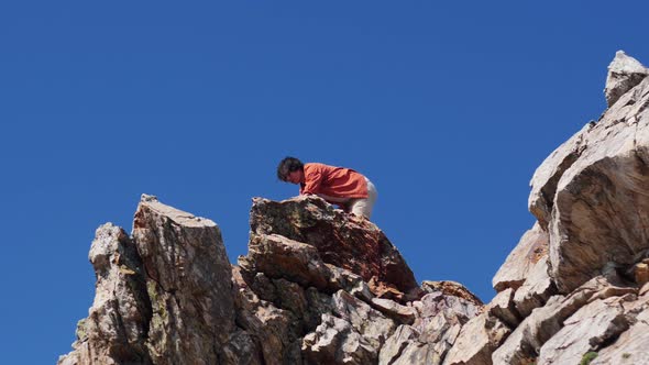 Young Man Having an Adventure - Walking on the Mountain and Looking Around