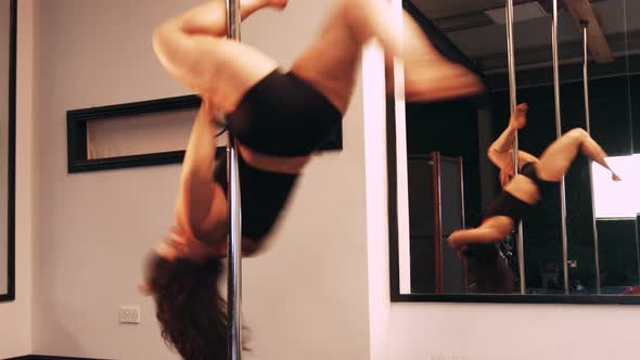 Pole dancers practicing pole dance