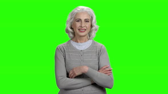 Senior Woman with Folded Arms on Green Screen