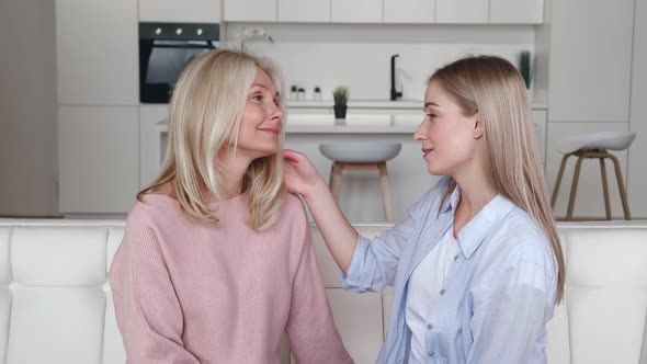 Caring Adult Grown Daughter Hugging with Love Her Senior Mature Beautiful Mom Enjoying Cuddling