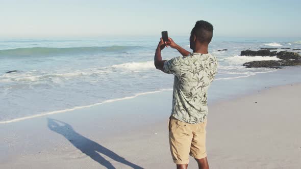 African American taking photo of the sea