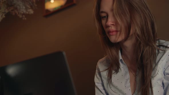 Young Woman is Passionate About Working in a Laptop