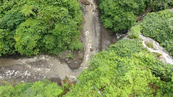 Aerial view of the river and streams in mountain gorge tropical forest.