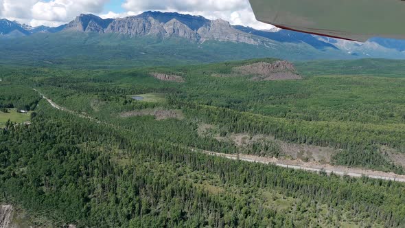Small airplane flight over the Matanuska River in the Talkeetna Range west of Palmer Alaska.