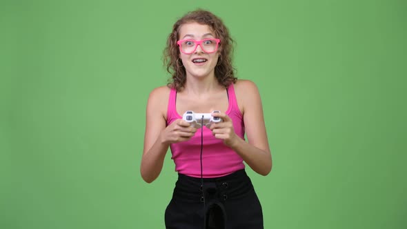 Young Happy Beautiful Nerd Woman Playing Games and Winning