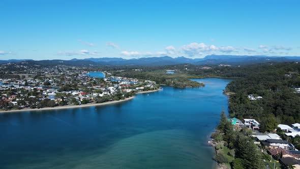 High drone view of Tallebudgera Creek and estuary with a mountain backdrop Gold Coast Australia