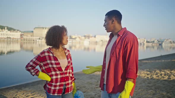 Black Man Talks with Woman About Successful Cleaning Beach