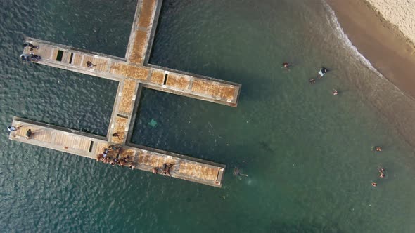 Local kids playing on dock top-down drone footage