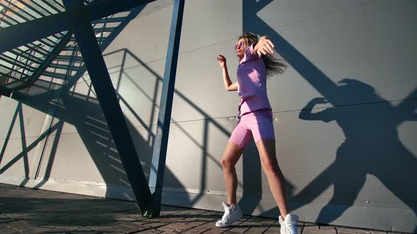 Female Street Dancer Performing Funky or Hip Hop Dance in Sunny Daytime
