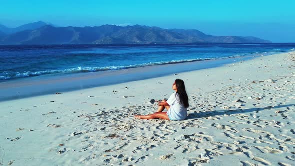 Girls posing on paradise island beach vacation by blue sea with white sand background of Gili Meno a