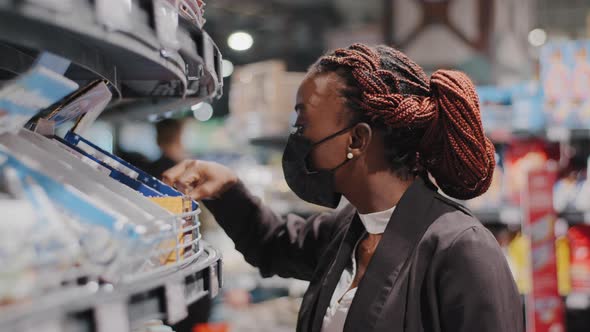 Closeup Side View African American Girl in Medical Mask Young Woman Female Consumer Shopper Stands