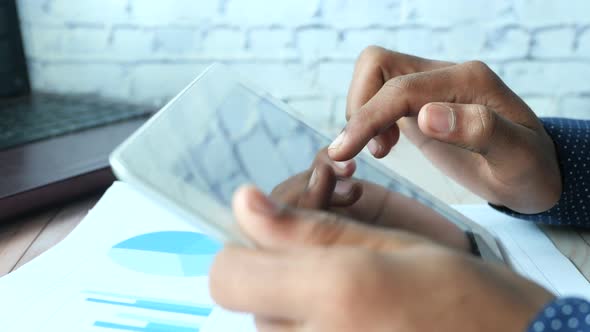 Businessman Using Digital Tablet on Office Desk