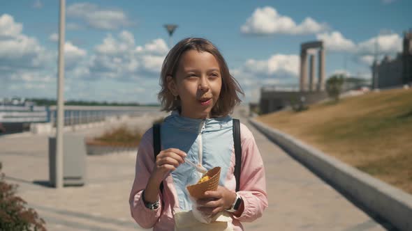 Little Child with Ice Cream on the Street. The Concept of Childhood, Lifestyle, Food, Summer. Little