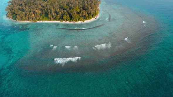 Aerial: flying over desert island tropical beach caribbean sea turquoise water c