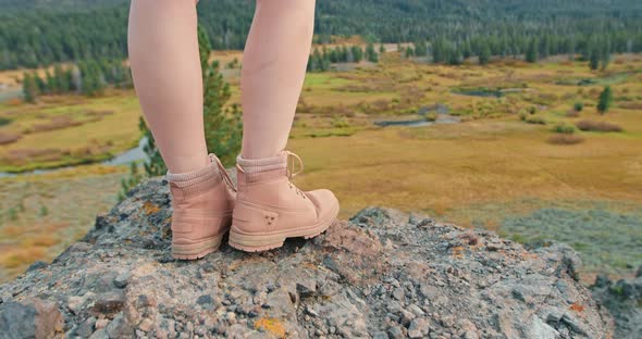 Close Up Woman Legs in Pink Hiking Boots on the Rock with Green Forest View
