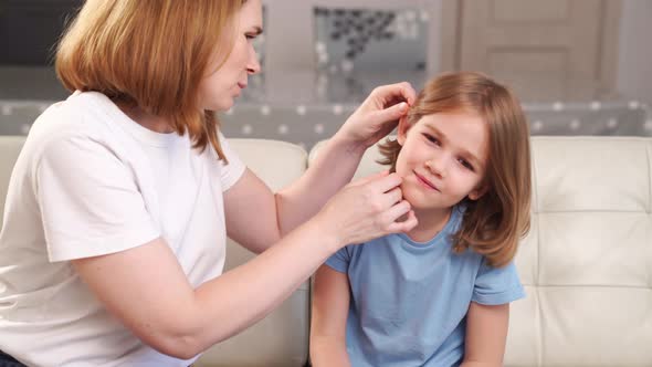 a Girl Complains of Pain in Ear and Her Mother Examines It