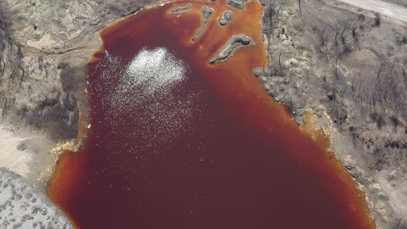 Red acidic water from mining process 4K aerial video