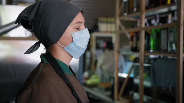 Quarantined Work, Tired Cook Employee or Confectioner in Medical Mask To Protect Against Virus Wipes