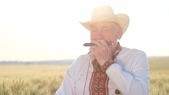 An Elderly Ukrainian in an Embroidered Jacket Plays the Harmonica