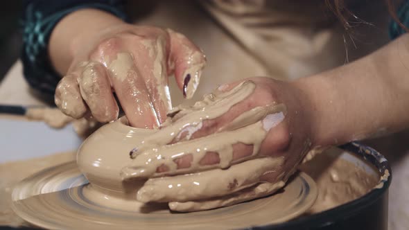 Pottery Crafting  Woman's Hands Forms Clay in the a Pot Shape