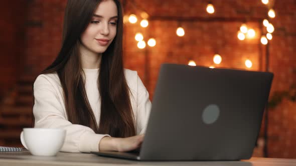 A Woman is Sitting in Her Home Office