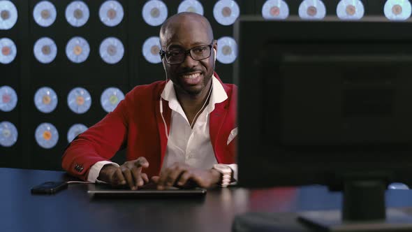 Smiling Black Man Listens Music Via White Phone Headset Sings Types Keyboard