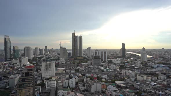 Pan right to left over the city of Bangkok at sunset.