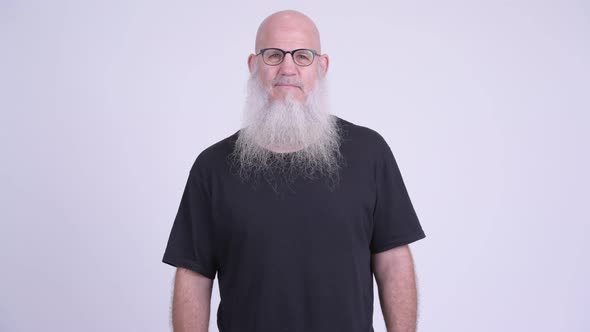 Mature Bald Man with Long Beard Wearing Eyeglasses Against White Background