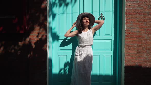 Wide Shot Carefree Beautiful Woman in White Dress Standing at Green Door and Red Wall in Ancient
