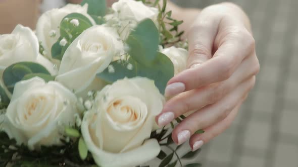 Bride Hand Touching the Wedding Bouquet