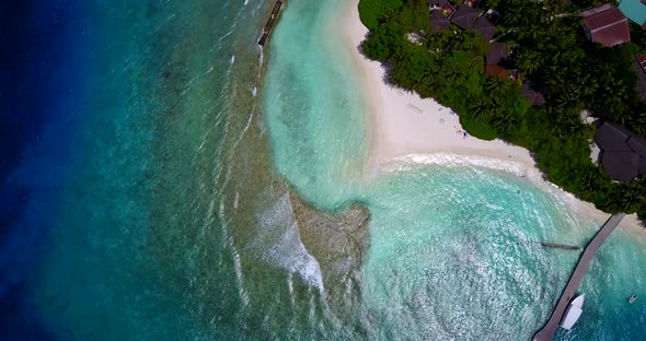 Luxury fly over copy space shot of a white paradise beach and blue ocean background in colorful 4K