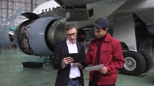 Engineers discuss the repair of the aircraft