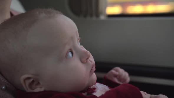 Cute Baby Girl of Six Months Traveling with Mum By Car