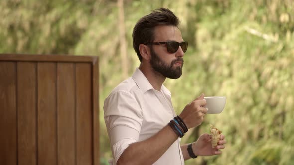 Businessman Drinking Coffee And Eating Croissant. Businessman Drinking Tea On Vacation. Caribbean.