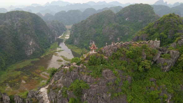 Aerial Shot of the Small Temple and a Dragon on the Top of Marble Mountain Mua Cave Mountain in Ninh