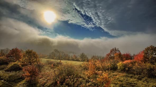 Fast and dynamic time-lapse, autumn meadow and movement of clouds and fog